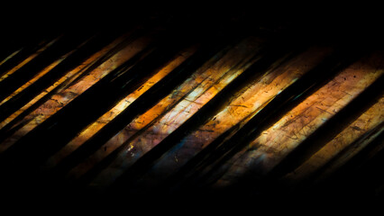 Detail of colorful yellow labradorite semi-precious gemstone. Close-up of the texture