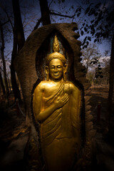 Golden Buddhist statues and carving showing intricate details and textures created by Buddhist...