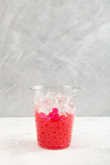 Preparation refreshing iced cocktail in disposable plastic cup. Boba drink or bubble tea. Summer fruit and berry drink. Take away, street food