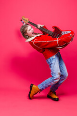 Musical Ideas. Expressive Caucasian Teenage Guitar Player With Red Polished Bass Guitar Posing In...