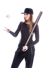 Fitness and Sport Concepts. One Sportive Caucasian Female Baseball Player Athlete Tossing Up Ball with Bat wearing Sport Outfit Against Pure White background.