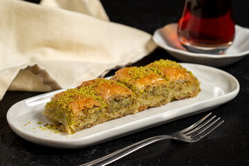 Pistachio baklava. Baklava with pistachio on a dark background. Traditional Mediterranean cuisine flavor. close up