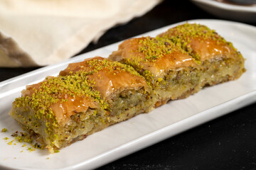 Pistachio baklava. Baklava with pistachio on a dark background. Traditional Mediterranean cuisine...