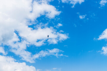 A paraglider on the background of a beautiful blue sky. Top view of the embers in the Beskid Mały. A popular place in Silesia. Bielsko Biała, Poland