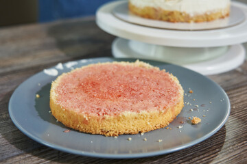 round cake crust on a plate soaked in rose syrup