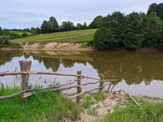 a barrier that enters the pond