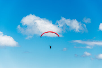 Paraglider flight against a beautiful blue sky. Top view of the embers in the Beskid Mały. A...