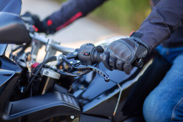 Obraz na płótnie Canvas Motorcyclist holding the handlebars of a motorcycle