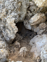 A big Sandstone rock with a hole. A rock face with holes of different sizes.