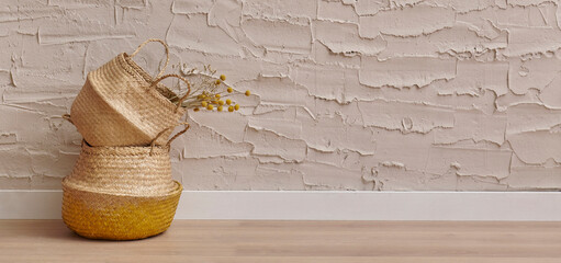 Wicker home object, bag, vase, mirror, baggage, plant in front of the concrete stone wall background, cotton dry plant, hanging, chair, blanket, decoration interior house room.