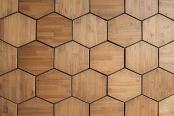 Texture of the wall, lined with wooden tiles in the shape of a hexagon. Wooden panel consisting of...