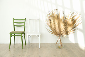 Two vintage chairs in interior of an empty white room. Sunny interior concept mock up. Autumn...