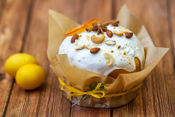 Delicious Easter cake and eggs. Russian Easter bread (Kulich) on a wooden board. 
