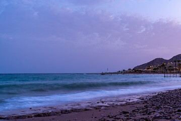 Dusk view outside of Eilat, Israel of Israel coastline and the Red Sea during the blue hour. 
