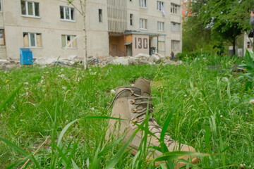 Lost military boot in the grasses. Consequences of Russian invasion at Ukraine