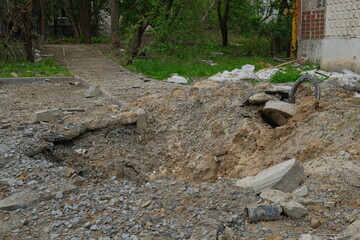 A shelling crater in a garden in a Ukrainian city.