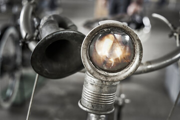 Lamp with shattered glass on handlebars of antique bicycle