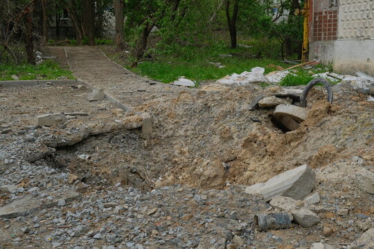 A shelling crater in a garden in a Ukrainian city.