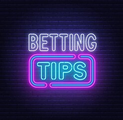 Betting tips neon sign on a brick background.