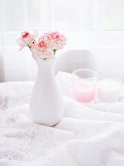 Pink white pastel Dianthus Carnation flowers in vase on embroidered Clove pink still life for background or wallpaper text letter ,mother's day ,women's day soft color romantic love tone copy space 