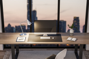 Bright office interior with book shelves, furniture, panoramic city view at dawn and empty mock up computer screen. Creative designer desktop concept. 3D Rendering.
