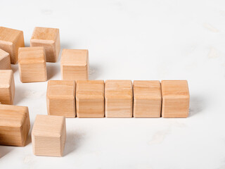 5 empty wooden cubes among a group of others and a space for text