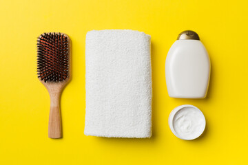 cosmetic for hair care, cream and towel on a colored background top view. flat lay