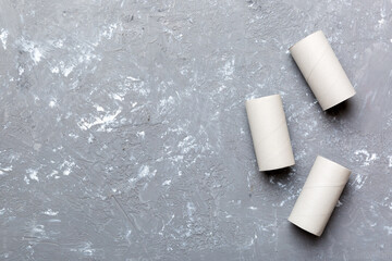 Flat lay composition with empty toilet paper rolls and space for text on color background. Recyclable paper tube with metal plug end made of kraft paper or cardboard