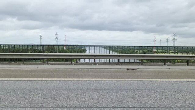 Side window view out of a driving car from the north baltic canal bridge at the highway A7 in Germany.