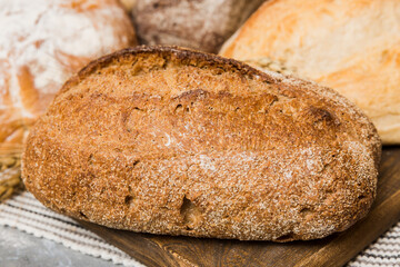 Homemade natural breads. Different kinds of fresh bread as background, perspective view with copy space