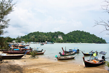 Fototapeta na wymiar View landscape seascape and local thai fisher people floating stop boat ship in sea waiting catch fish and marine life at Pak Bara fishing village at La ngu city on April 12, 2022 in Satun, Thailand