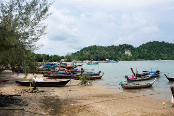 Naklejka na ściany i meble View landscape seascape and local thai fisher people floating stop fishing boat ship in sea waiting catch fish and marine life at waterfront Pak Bara fishing village at La ngu city of Satun, Thailand