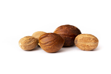 Nutmeg close-up on a white background. Indian spices close up. Medicinal herbs and spices.