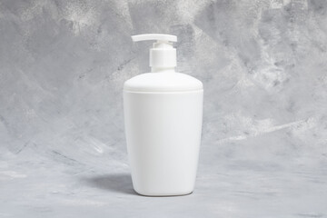 white plastic dispenser on a gray background