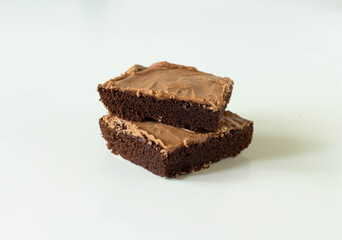 Two pieces of brownie cake on a white background