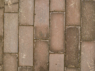 The texture of the paved tile on the bottom of the street. Cement brick squared stone floor background. Concrete paving slabs. Paving slabs