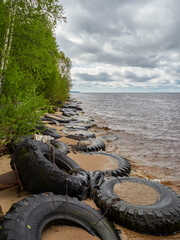 view of the sandy beach by the Baltic Sea. Seashore with old car tires and concrete, human waste, Curonian Spit, Russia