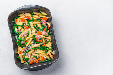 Preparation of vegetable, dietary stew with turkey meat. Raw vegetables and turkey meat in a baking dish. Healthy food.