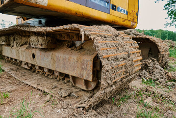 Fototapeta na wymiar Yellow excavator on construction site, Heavy construction machine excavating soil, Crawler backhoe working at dirt soil