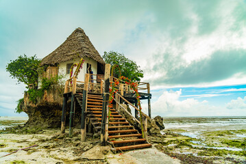 The Rocks restaurant on the beach during low tide. Pingwe, Zanzibar, Tanzania - obrazy, fototapety, plakaty