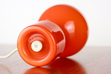 A 60s modern orange bedside lamp with glass spaceage vintage midcentury design front side view...