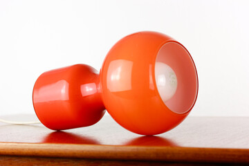 A 60s modern orange bedside lamp with glass spaceage vintage midcentury design front side view...
