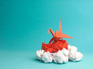 New ideas or transformation concept with crumpled paper balls and a crane, teamwork, creativity, business concept