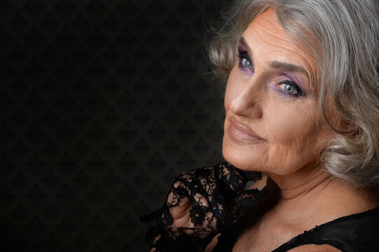 Portrait of a beautiful elderly woman with makeup