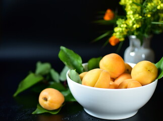 still life with apricots on a dark background
