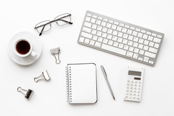 Silver colored office supplies on office desk, top view