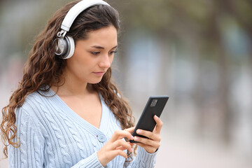 Serious woman with headphones listening to music