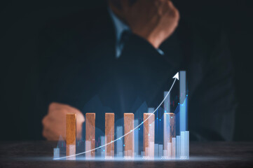 Businessman in suite showing rising sign Stock chart with graph indicator. financial data exchange