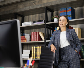smart businesswoman stands working in workplace, wears suit, calling and looking at computer for online meeting. beautiful young woman look as businesswoman or worker working business in office