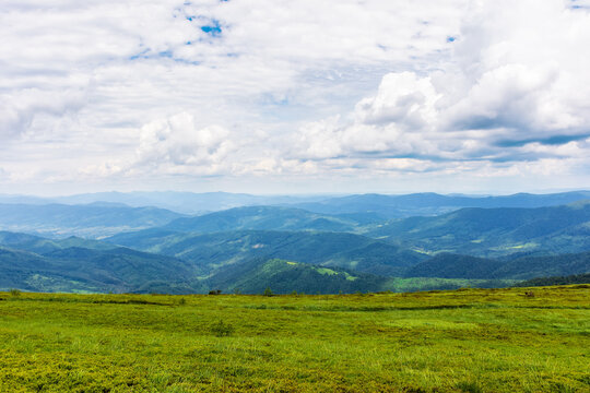 green landscape in dappled light. grassy hills of carpathian mountain scenery on a sunny day. sky with clouds above horizon
